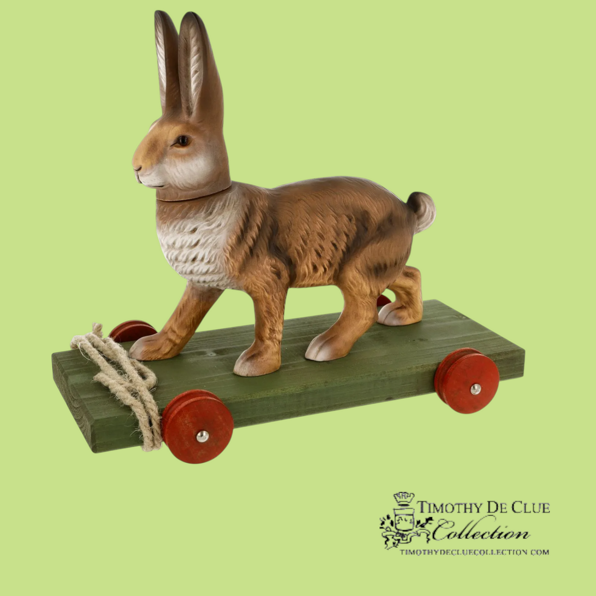 Bunny Pull Toy Vintage Inspired German Paper Mache with brown and white finish on green wooden base with red wheels and rope pull