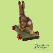 Bunny Pull Toy Vintage Inspired German Paper Mache with wooden body and red wheels on green base