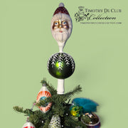 Kringle Finial Tree Top with bearded Santa head, dark green ornament, and decorated evergreen base with colorful baubles