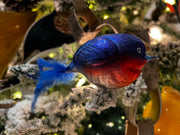 Bluebird Clip Bird feather Tail hand blown glass Christmas ornament, blue and red, displayed on frosted branch with lights