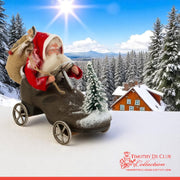 Driving Shoe Crazy Santa in shoe-shaped vehicle against snowy mountain landscape with forest cabin backdrop