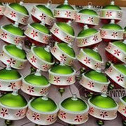 Christmas Rose 3.25 in Drop Antik Baubles Ornaments, green and white with floral design, displayed in rows