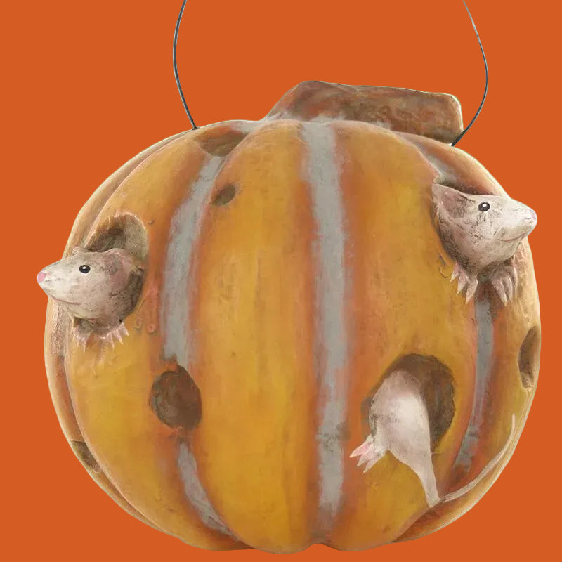Decorative pumpkin paper mache with small mice figures on a white background