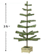 A 3-foot tall artificial Christmas tree with green feathers, displayed on a white square base with a measurement scale on the side.