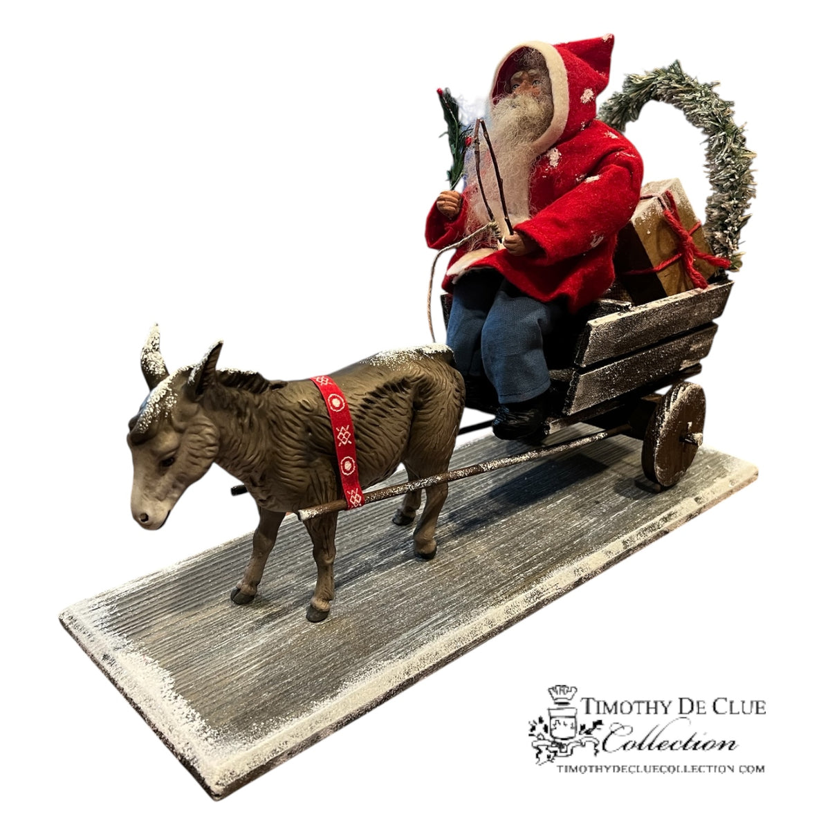 Donkey Cart Santa Candy Container, German paper mache figurine in red coat with evergreen wreath, seated on wooden cart pulled by gray donkey.