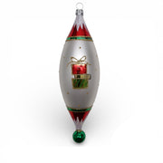 Celebrate holiday charm with this hand-blown German glass ornament featuring Christy on a festive city shopping trip—her stylish husband by her side, helping carry home her beautifully wrapped treasures. Classic reds, greens, and soft silver tones give this whimsical scene a warm, vintage Christmas glow.

Made in Germany • Designed by Timothy DeClue