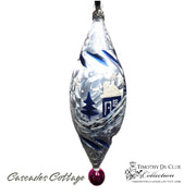 Cascades Cottage glass ornament with blue winter scene, house, and trees, red ball base