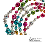Bavarian Court Bead Garland with multicolored faceted beads in pink, teal, green, and gold draped in diagonal strands.