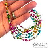 Bavarian Court Bead Garland held in hand showing multicolored faceted beads with silver spacers and matching earring.