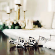 Bit Napkin Rings displayed in place setting with white linens and candles