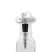 Cowboy Hat Bottle Stopper with silver finish and black cork insert in clear glass bottle