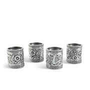 Concho Pattern Napkin Rings Set of 4 arranged in a row, silver metal with ornate engraved details