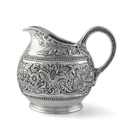 Concho Pattern Pitcher, silver metal with ornate floral embossed design and beaded trim
