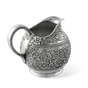 Concho Pattern Pitcher, silver metal with embossed floral design and beaded trim