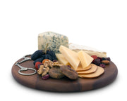 Cheese Board - Equestrian Bit with assorted cheeses, grapes, walnuts, dried fruit, and metal bit-shaped server on brown wooden round platter.