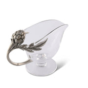 Artichoke Glass Gravy Boat with metal handle featuring leaf detail, shown from side angle.