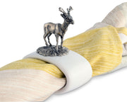 Deer Stoneware Napkin Ring with metallic stag figurine on white base, draped on yellow and cream striped fabric.