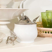 Acorn Oak Leaf Sugar Bowl and Spoon displayed on shelf with white dishes and green glassware.